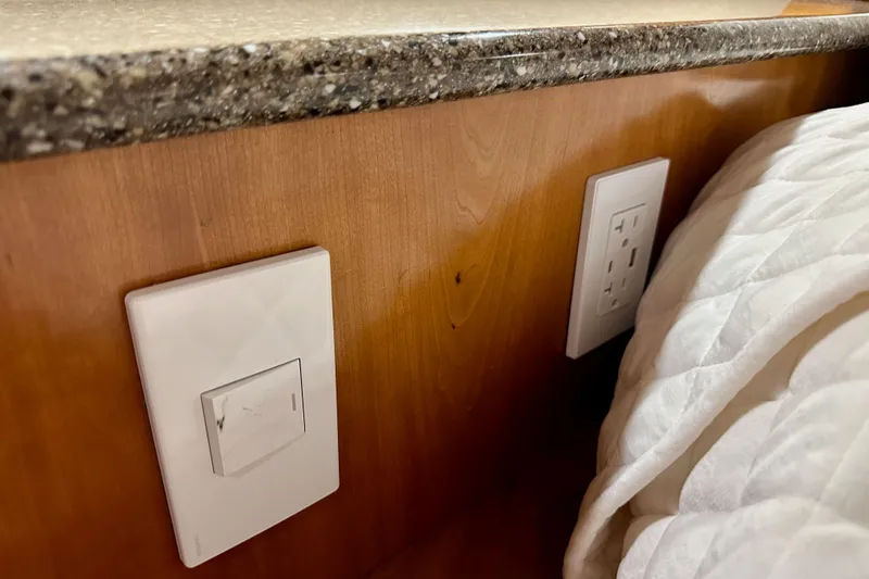 Slide: The Image of Light switch and outlet on wooden panel in 2004 Meridian 580 Pilothouse yacht interior. - 150