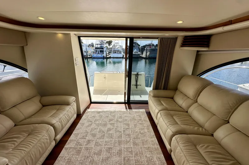 Slide: The Image of Luxurious interior of 2004 Meridian 580 Pilothouse yacht with leather seating and marina view. - 164