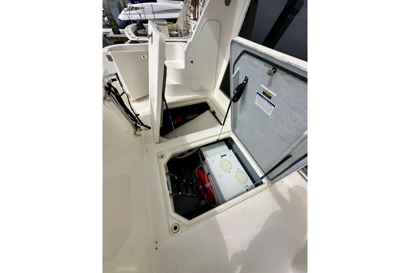 Slide: The Image of Open hatch on 2004 Meridian 580 Pilothouse boat, revealing storage compartment. - 21