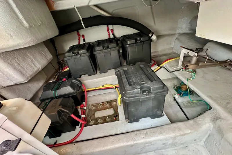 Slide: The Image of Battery compartment of a 2004 Meridian 580 Pilothouse yacht, featuring multiple battery units. - 24