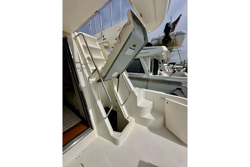 Slide: The Image of 2004 Meridian 580 Pilothouse yacht with stairs and open hatch, docked at marina. - 26