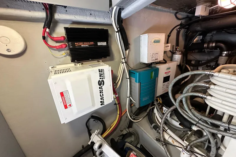 Slide: The Image of Engine room of 2004 Meridian 580 Pilothouse with battery equalizer and wiring. - 30