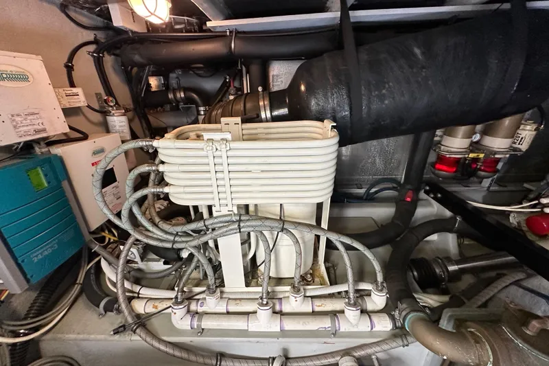 Slide: The Image of Engine room of 2004 Meridian 580 Pilothouse with complex piping and machinery. - 31