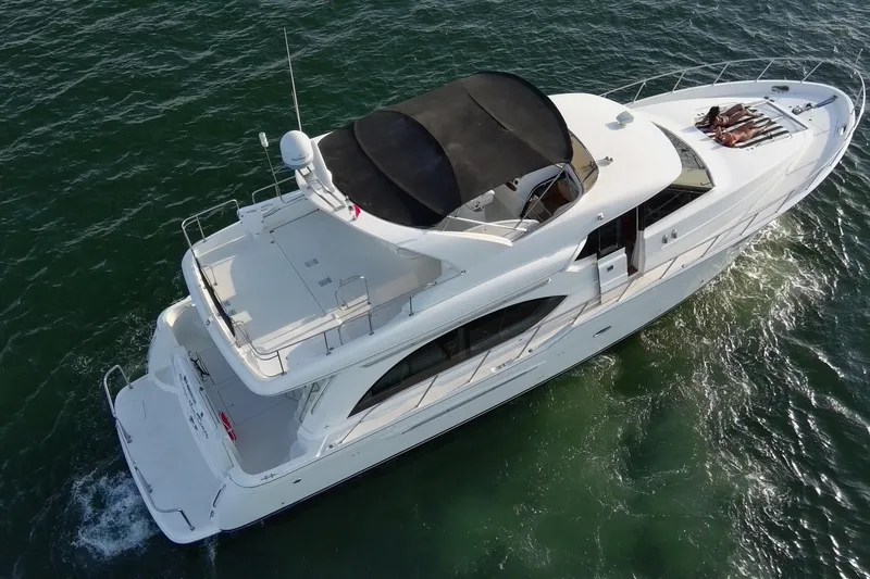Slide: The Image of 2004 Meridian 580 Pilothouse yacht cruising on open water, aerial view. - 6