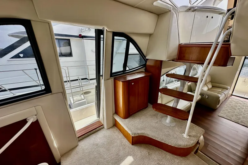 Slide: The Image of Luxurious interior of 2004 Meridian 580 Pilothouse yacht with elegant wooden staircase. - 62
