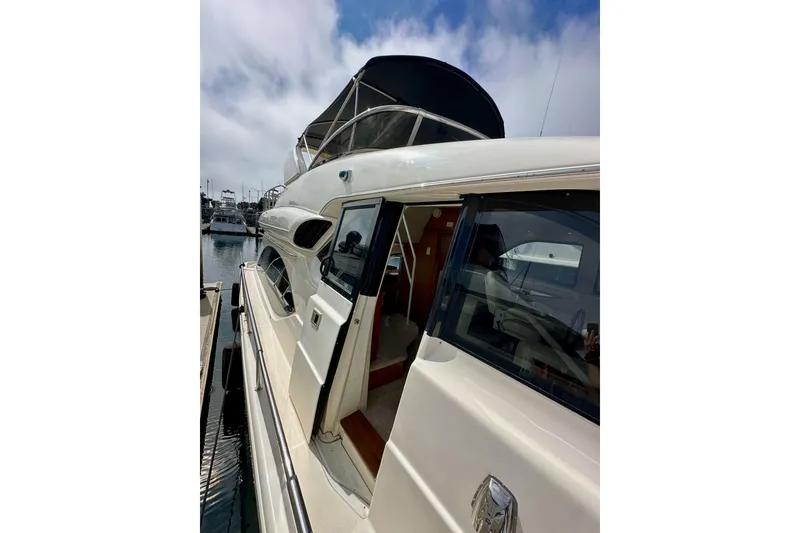 Slide: The Image of 2004 Meridian 580 Pilothouse yacht docked at marina under cloudy sky. - 69