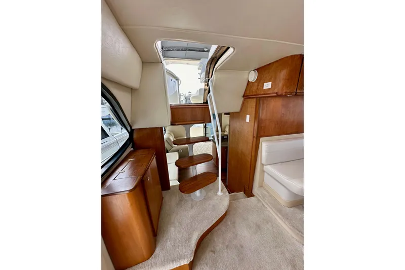 Slide: The Image of Interior of 2004 Meridian 580 Pilothouse yacht with wooden stairs and seating area. - 70