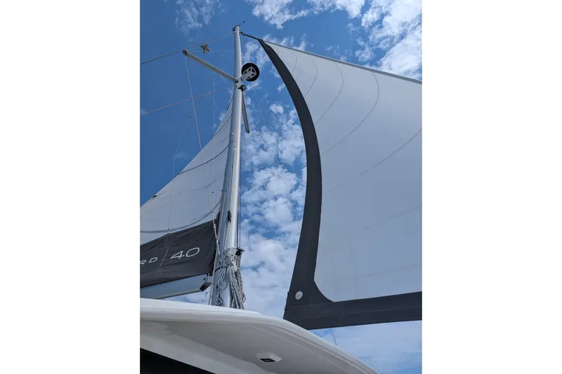 Slide: The Image of Sailing yacht Leopard 40, 2020 model, with sails unfurled against a blue sky. - 105