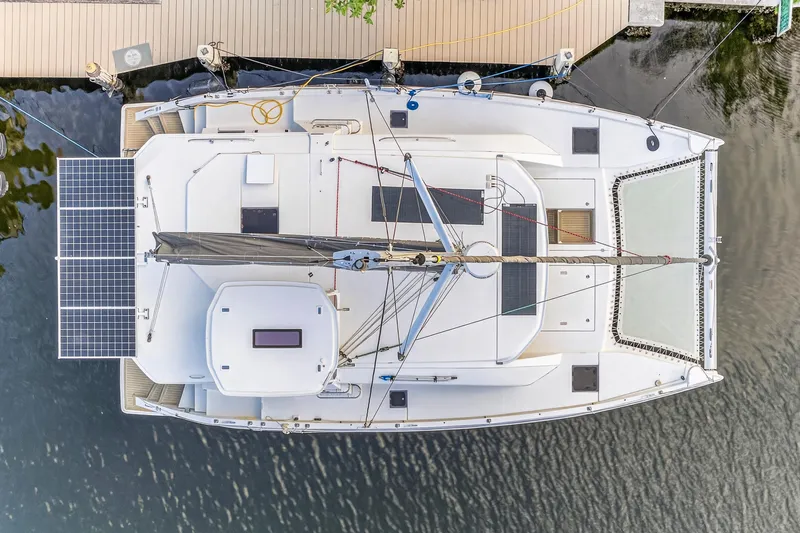 Slide: The Image of Aerial view of 2020 Leopard 40 catamaran docked, featuring solar panels and spacious deck. - 11