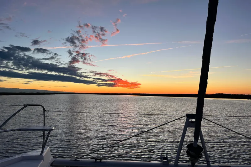 Slide: The Image of Sailing on a 2020 Leopard 40 catamaran at sunset, tranquil waters and vibrant sky. - 110