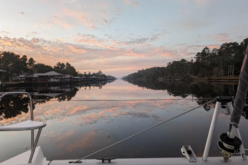 Slide: The Image of Sailing on a Leopard 40 catamaran at sunset, reflecting on calm waters, 2020 model. - 111