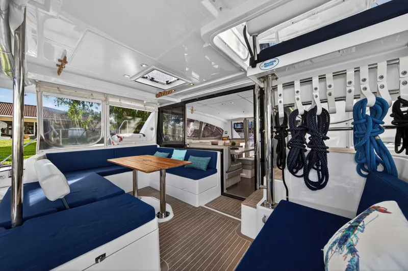 Slide: The Image of Luxurious 2020 Leopard 40 catamaran interior with blue seating, wooden table, and nautical decor. - 12