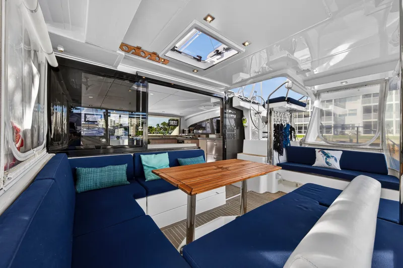 Slide: The Image of Luxurious interior of 2020 Leopard 40 catamaran with blue seating and wooden table. - 13