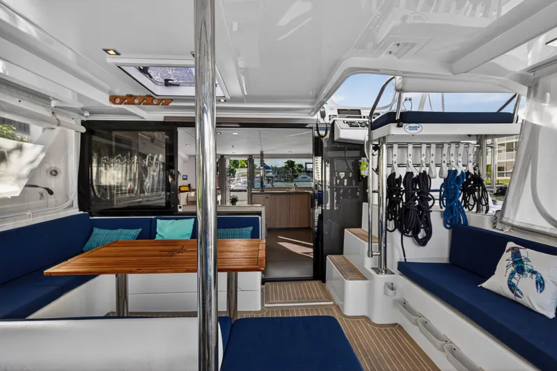 Slide: The Image of Luxurious 2020 Leopard 40 catamaran interior with blue seating and wooden table. - 14