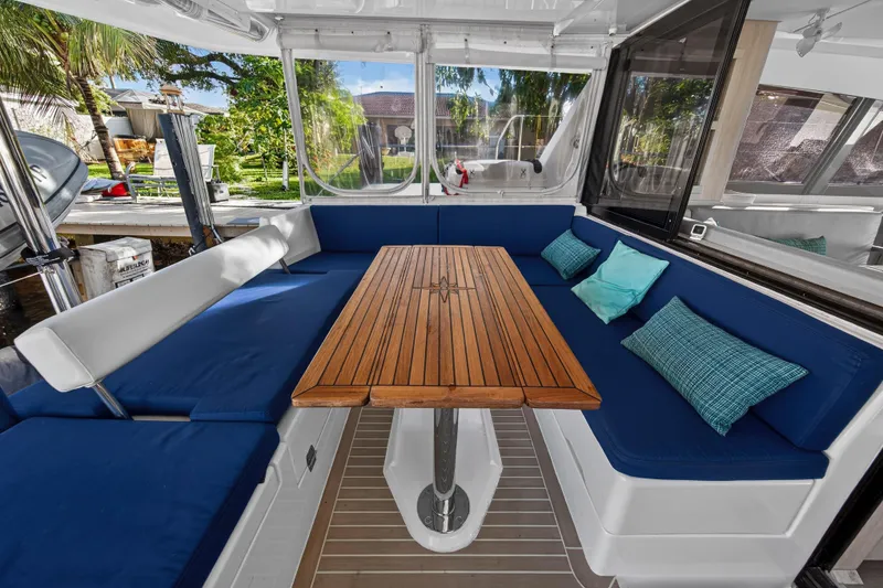 Slide: The Image of Leopard 40 catamaran interior with blue seating and wooden table, 2020 model. - 16