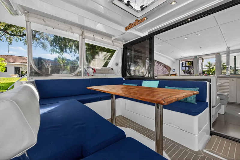 Slide: The Image of Spacious interior of 2020 Leopard 40 catamaran with blue seating and wooden table. - 17