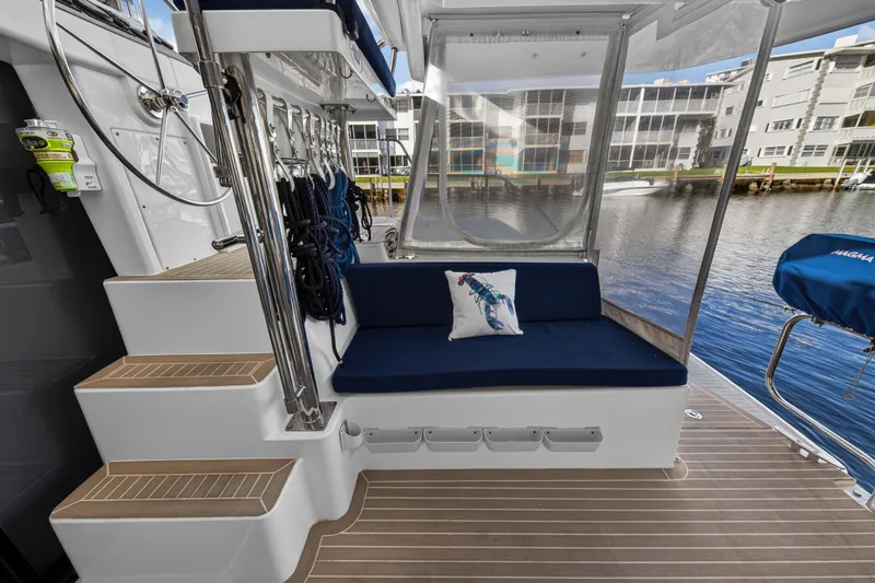 Slide: The Image of 2020 Leopard 40 yacht interior with blue seating, nautical decor, and marina view. - 19