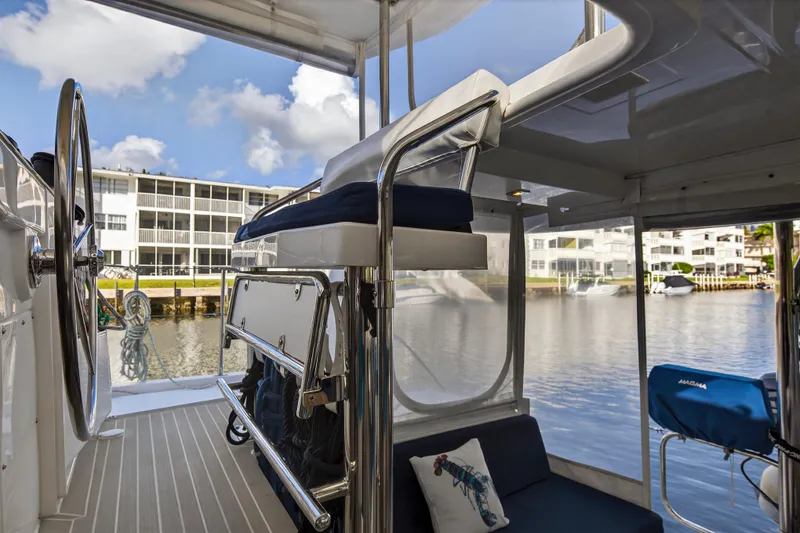 Slide: The Image of Modern Leopard 40 catamaran interior with steering wheel, seating, and marina view. - 21