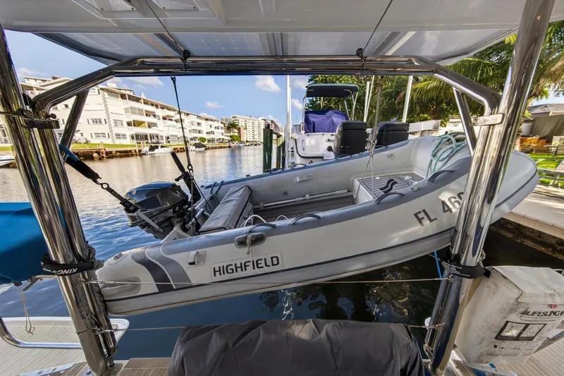 Slide: The Image of Leopard 40 catamaran with Highfield dinghy, docked in a scenic waterfront location, 2020 model. - 22