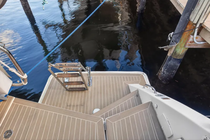 Slide: The Image of Stern view of 2020 Leopard 40 catamaran with swim ladder and dock. - 26