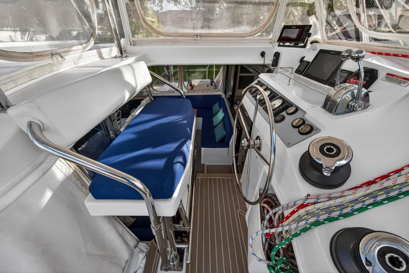 Slide: The Image of Helm station of 2020 Leopard 40 catamaran with blue seating and navigation controls. - 29