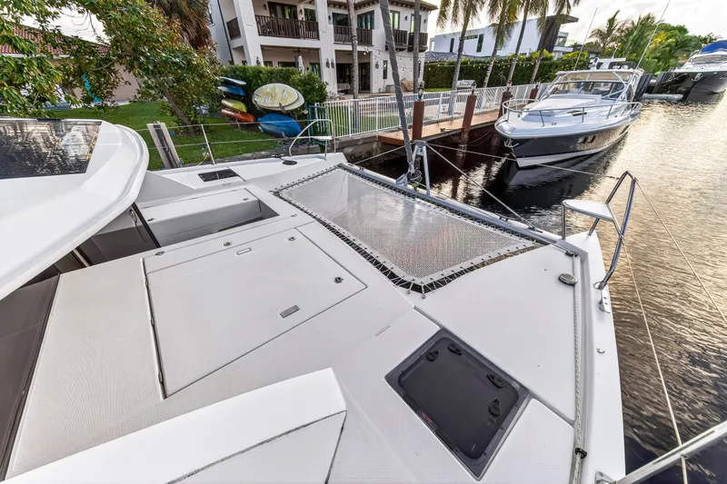 Slide: The Image of 2020 Leopard 40 catamaran docked near waterfront homes and boats. - 36