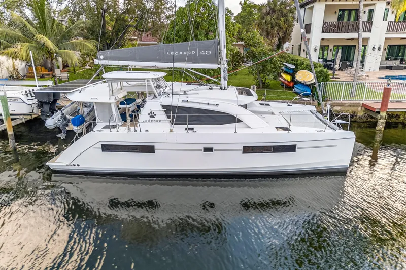 Slide: The Image of 2020 Leopard 40 catamaran docked by waterfront property, featuring sleek design and modern amenities. - 4