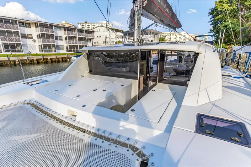 Slide: The Image of 2020 Leopard 40 catamaran docked near waterfront buildings under a clear sky. - 40