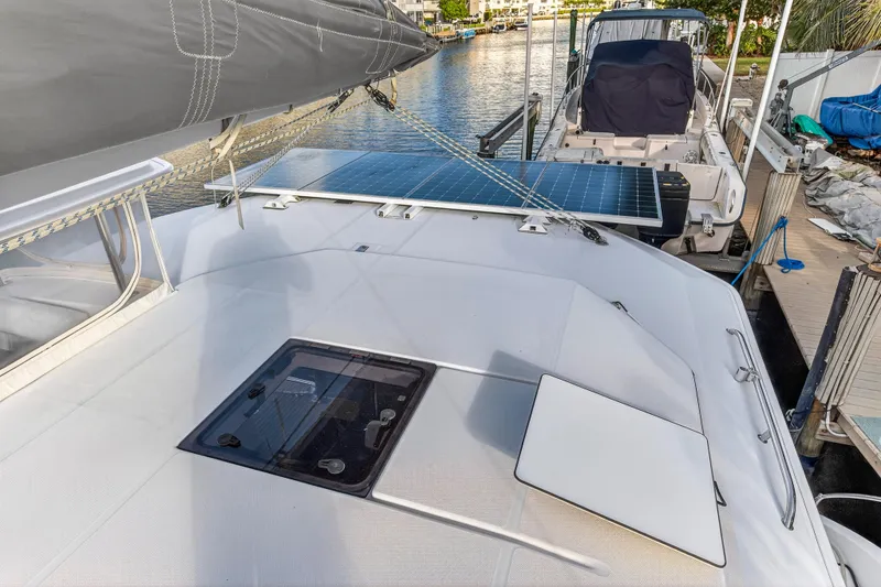 Slide: The Image of 2020 Leopard 40 catamaran with solar panels docked at a marina. - 49