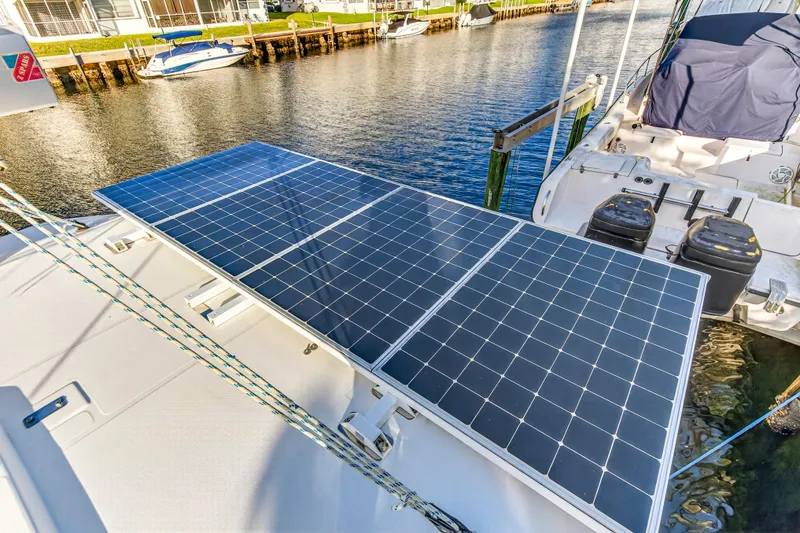 Slide: The Image of Solar panels on a 2020 Leopard 40 catamaran docked by a waterfront. - 50