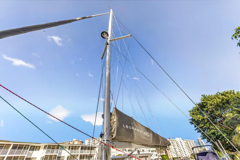 Slide: The Image of Sailboat mast of 2020 Leopard 40 against blue sky and urban backdrop. - 52