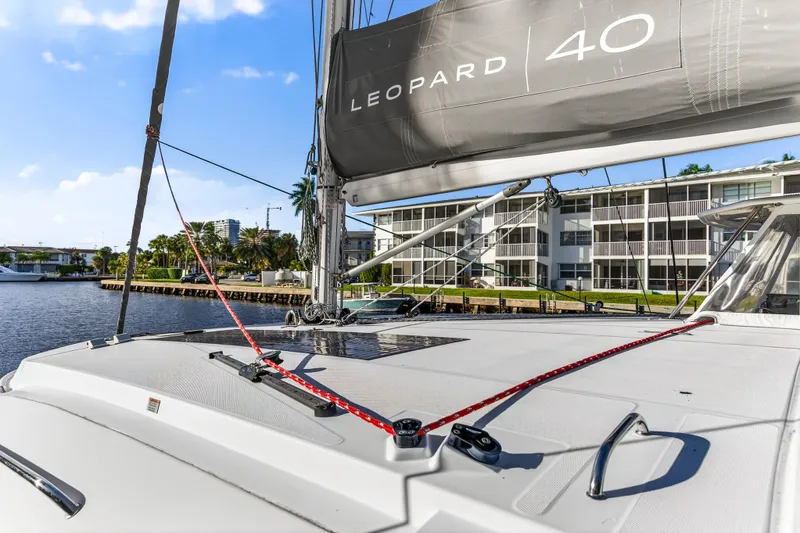Slide: The Image of 2020 Leopard 40 catamaran docked, showcasing deck and sail details. - 54