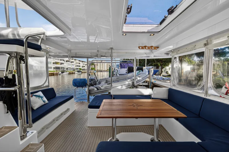Slide: The Image of Spacious interior of 2020 Leopard 40 catamaran with blue seating and wooden table. - 55