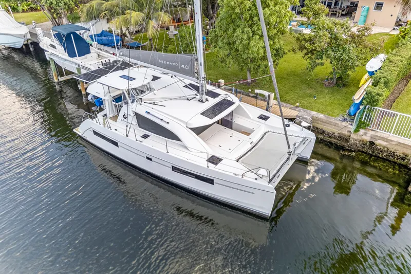 Slide: The Image of Aerial view of a 2020 Leopard 40 catamaran docked by lush greenery. - 8