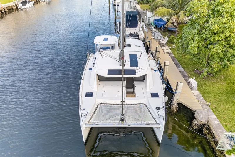 Slide: The Image of 2020 Leopard 40 catamaran docked in a serene canal setting. - 9