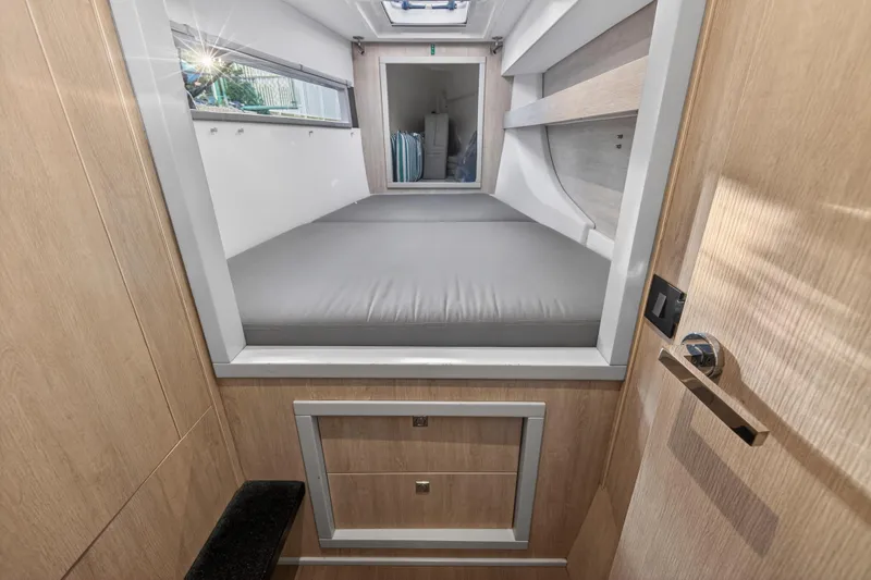 Slide: The Image of 2020 Leopard 40 interior cabin with bed, wooden finish, and storage drawers. - 94