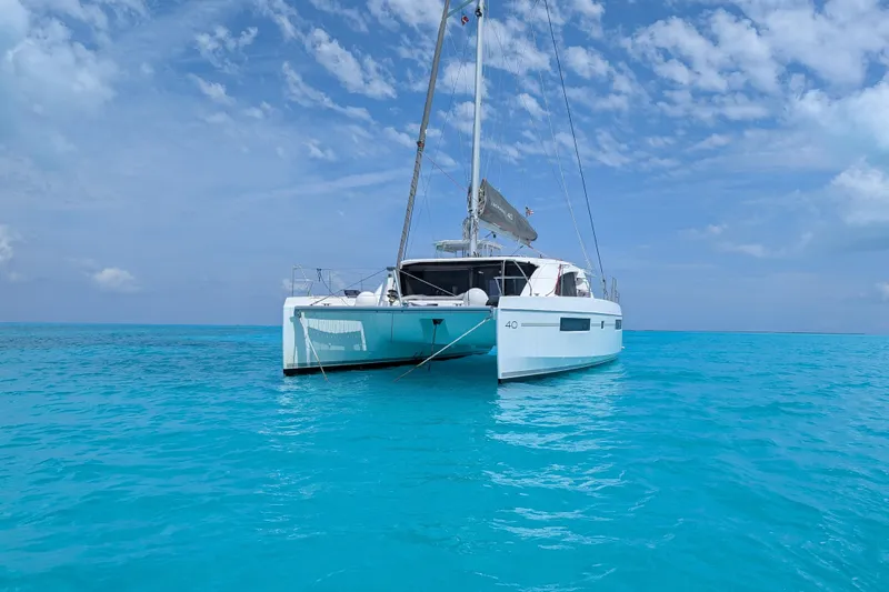Slide: The Image of 2020 Leopard 40 catamaran sailing on clear turquoise waters under a blue sky. - 99