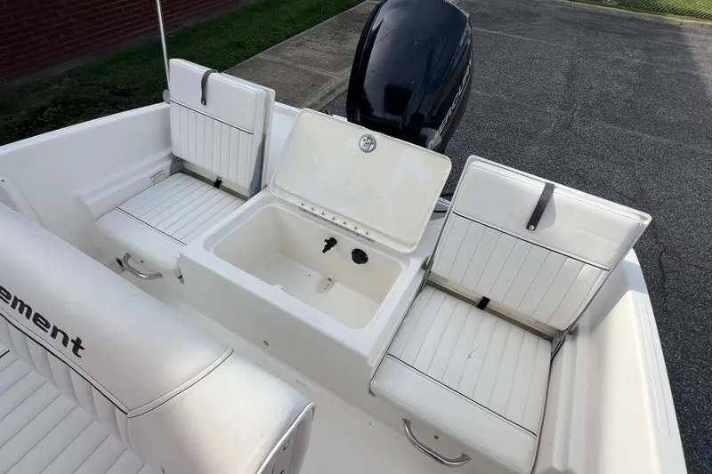 Slide: The Image of 2020 Bayliner Element F18 boat interior with seating and storage compartment. - 10