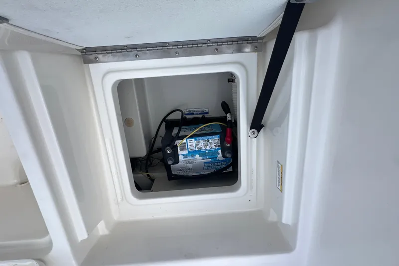 Slide: The Image of Battery compartment of 2020 Bayliner Element F18 boat, featuring marine battery setup. - 11