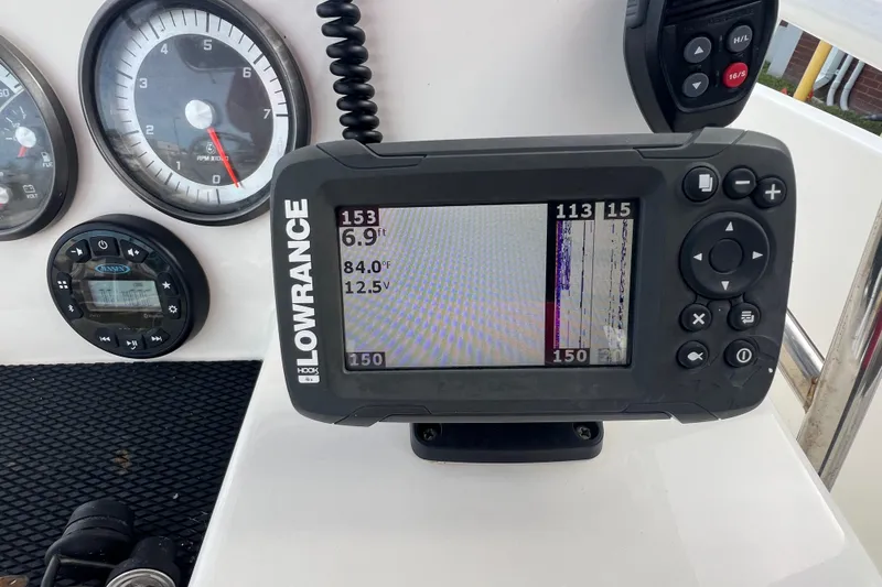 Slide: The Image of Dashboard of 2020 Bayliner Element F18 with Lowrance fishfinder and gauges. - 13
