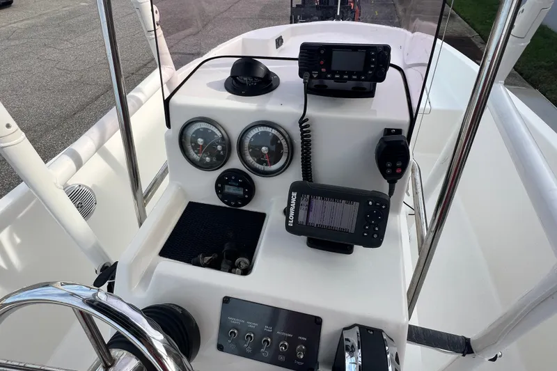 Slide: The Image of 2020 Bayliner Element F18 boat dashboard with gauges, controls, and navigation equipment. - 16
