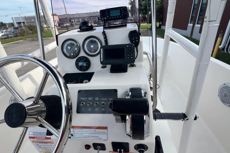 Slide: The Image of 2020 Bayliner Element F18 boat dashboard with steering wheel and navigation controls. - 17
