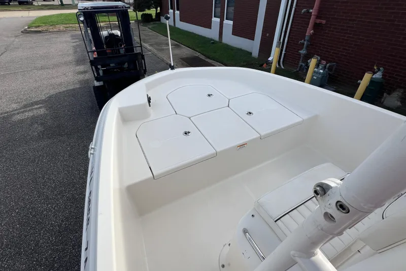 Slide: The Image of 2020 Bayliner Element F18 boat interior with white seating and storage compartments. - 18