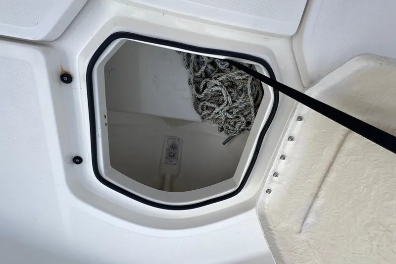 Slide: The Image of Storage compartment with rope on a 2020 Bayliner Element F18 boat. - 20