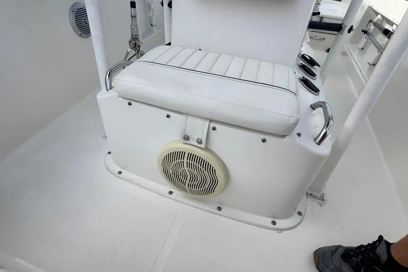Slide: The Image of 2020 Bayliner Element F18 boat interior with white seating and speaker. - 22