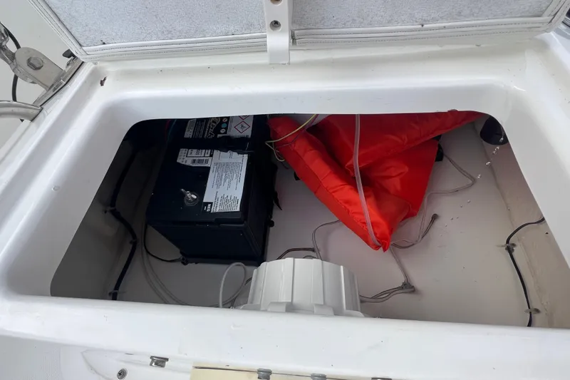 Slide: The Image of 2020 Bayliner Element F18 storage compartment with battery and life jacket. - 23