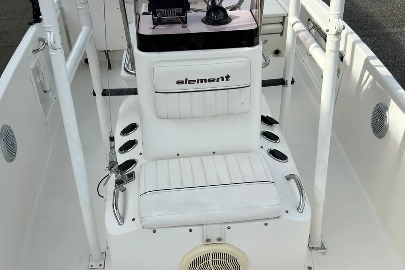 Slide: The Image of 2020 Bayliner Element F18 boat interior with white seating and rod holders. - 24