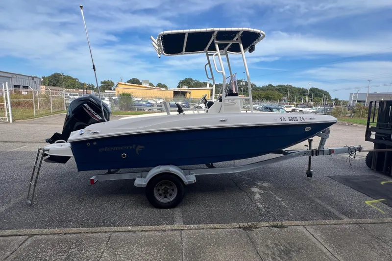 Slide: The Image of 2020 Bayliner Element F18 boat on trailer, parked outdoors under clear sky. - 5