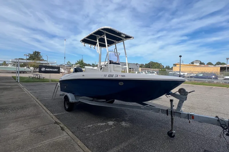 Slide: The Image of 2020 Bayliner Element F18 boat on trailer, parked outdoors under a clear sky. - 6