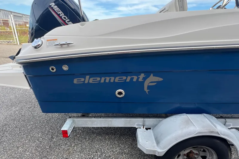 Slide: The Image of 2020 Bayliner Element F18 boat on trailer, featuring blue and white design. - 8